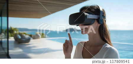 Woman Enjoying Virtual Reality Experience by the Ocean on a Sunny Day 117809541