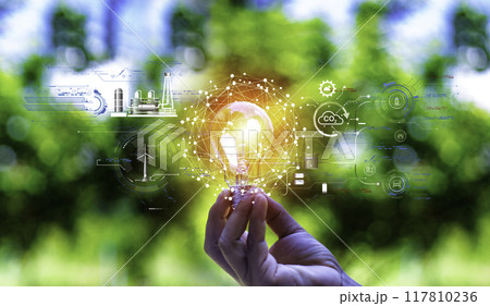 green energy concept help reduce global warming..Hand holding natural background light bulb on green leaf with clean energy icon around it. Carbon dioxide emission in industry zero carbon concept. green energy concept help reduce global warming..Hand holding natural background light bulb on green leaf with clean energy icon around it. Carbon dioxide emission in industry zero carbon concept. 117810236