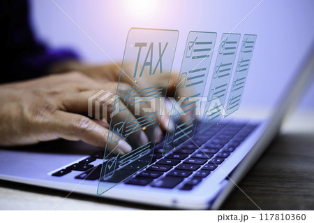 Businessman using laptop to fill in the income tax online return form for payment.business using computer filling personal income tax return to pay tax.Futuristic virtual screen interface technology. Businessman using laptop to fill in the income tax online return form for payment.business using computer filling personal income tax return to pay tax.Futuristic virtual screen interface technology. 117810360