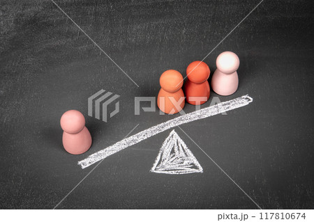 Minority opinion concept. Wooden human figures on a chalkboard background 117810674