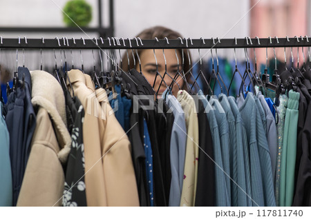 Smiling fat woman in plus size store looking at camera. Smiling fat woman in plus size store looking at camera. 117811740
