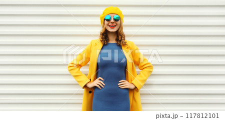 Autumn portrait of beautiful happy smiling woman in yellow french hat, stylish trendy girl posing 117812101