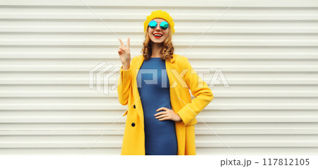 Autumn portrait of beautiful happy smiling woman in yellow french hat, stylish trendy girl posing Autumn portrait of beautiful happy smiling woman in yellow french hat, stylish trendy girl posing 117812105