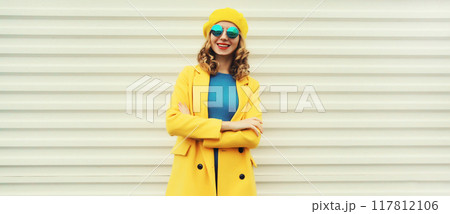 Autumn portrait of beautiful happy smiling woman in yellow french hat, stylish trendy girl posing 117812106