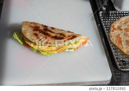 Flatbread stuffed with fish and cheese. Quesadilla. Flatbread stuffed with fish and cheese. Quesadilla. 117812892