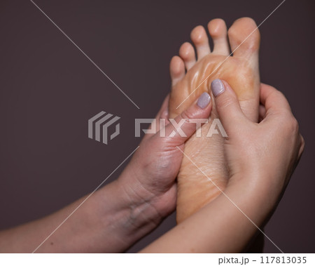 Close-up of a woman's foot massage. Close-up of a woman's foot massage. 117813035
