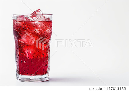 Chilled red drink with ice in a clear glass on a white background 117813186