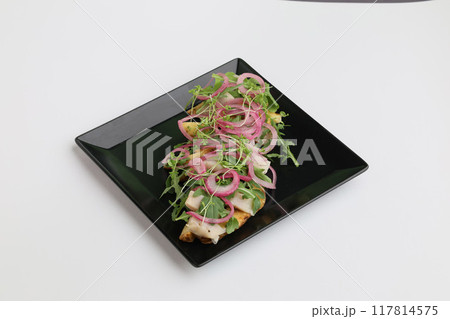 Sliced Herring with mini potatoes and red onion on dark plate top view on white background Sliced Herring with mini potatoes and red onion on dark plate top view on white background 117814575