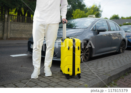 Catching a Cab. Male traveller standing near airport, waving hand, calling taxi driver, free space 117815379