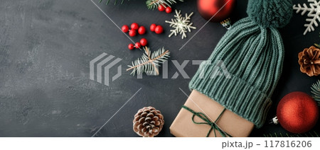 Festive Holiday Arrangement With Gift, Pine Branches, and Ornaments on Dark Surface 117816206
