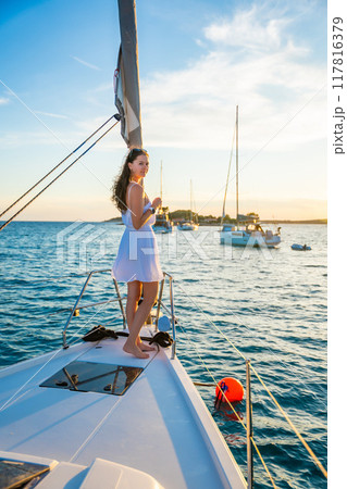 Young woman sailing, young adult lady enjoying summer travel, close-up portrait of female face, summer cruise holidays, European girl tourist traveling in sail boat in Croatia Young woman sailing, young adult lady enjoying summer travel, close-up portrait of female face, summer cruise holidays, European girl tourist traveling in sail boat in Croatia 117816379