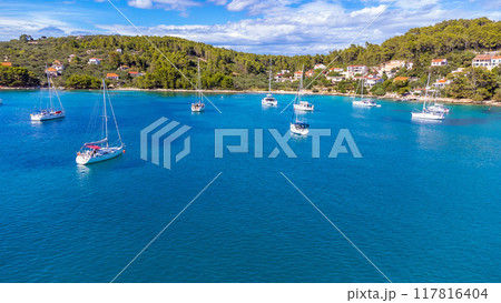 Drone view of yachts moored on buoys near the shore in the bay of Uvala Gradina near the town of Vela Luka on the island of Korcula in Croatia Drone view of yachts moored on buoys near the shore in the bay of Uvala Gradina near the town of Vela Luka on the island of Korcula in Croatia 117816404