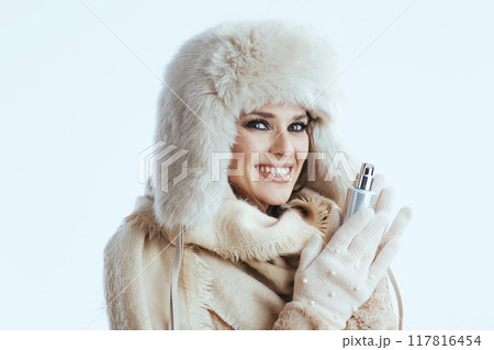 happy modern woman in winter coat and fur hat on white happy modern woman in winter coat and fur hat on white 117816454