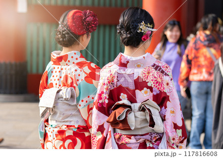 Young girl wearing Japanese kimono standing in front of Sensoji Temple in Tokyo, Japan. Kimono is a Japanese traditional garment. The word kimono, which actually means a thing to wear Young girl wearing Japanese kimono standing in front of Sensoji Temple in Tokyo, Japan. Kimono is a Japanese traditional garment. The word kimono, which actually means a thing to wear 117816608