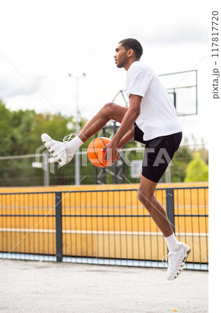 Tall young man in sportswear warming up before the game 117817720