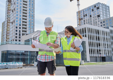 Two industrial construction workers discussing project plan for engineering work 117818336