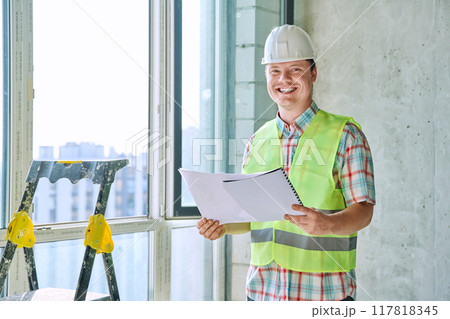 Portrait of male industrial worker in vest helmet with engineering documents Portrait of male industrial worker in vest helmet with engineering documents 117818345