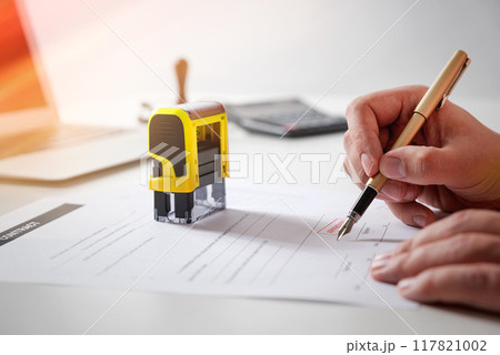 Businessman signing a contract on desk 117821002
