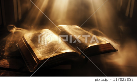 Bible open with light shining on pages Bible open with light shining on pages 117822855