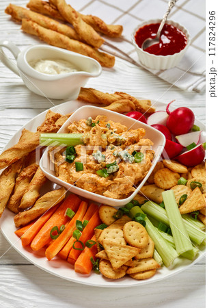 buffalo chicken dip with veggie and bread sticks 117824296