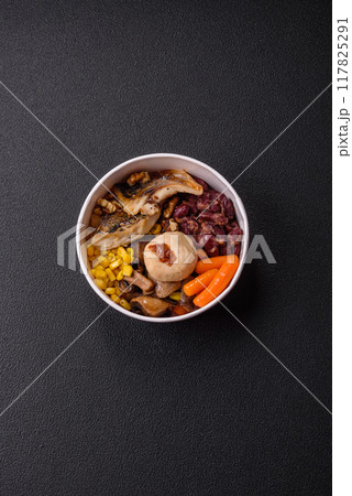 A colorful vegetarian dish consists of fish, beans, corn, mushrooms 117825291