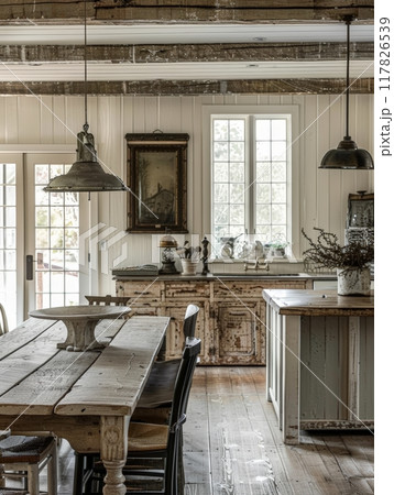 A rustic farmhouse kitchen with exposed beams, a farmhouse table, and a window overlooking the outdoors A rustic farmhouse kitchen with exposed beams, a farmhouse table, and a window overlooking the outdoors 117826539