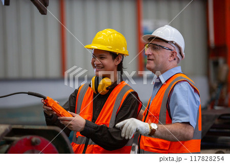 Professional team technician engineer factory workers use control remote for controlling industrial Professional team technician engineer factory workers use control remote for controlling industrial 117828254