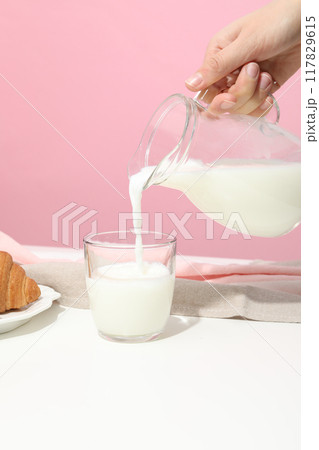 A glass of milk with croissants on the table A glass of milk with croissants on the table 117829615