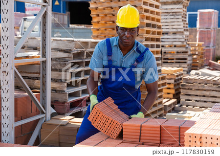 Male worker controlling quantity of ceramic tiles 117830159