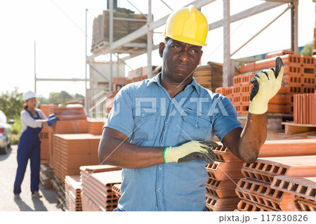 Worker beckoning come here at construction store Worker beckoning come here at construction store 117830826