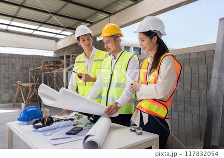 Engineers Discussing Construction Blueprints on Site. Focus on Project Execution Engineers Discussing Construction Blueprints on Site. Focus on Project Execution 117832054