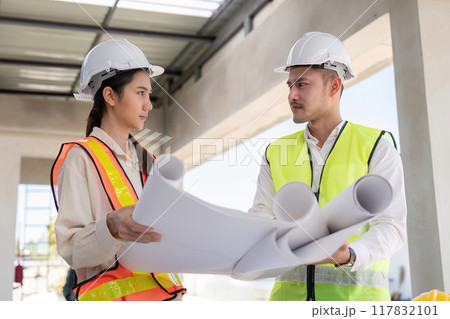 Engineers Reviewing Construction Blueprints on Site. Design and Coordination 117832101