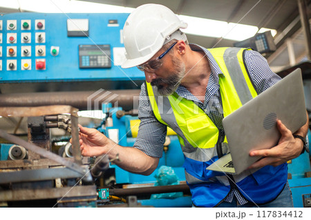 Industrial man engineer supervisor wear uniform and helmet using laptop are checking system Industrial man engineer supervisor wear uniform and helmet using laptop are checking system 117834412