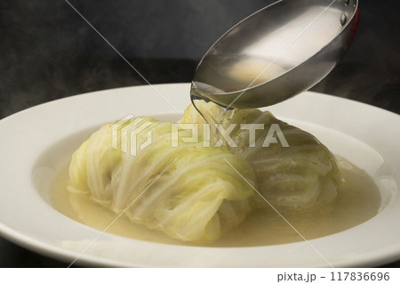 ロルキャベツ　皿に盛り付けたロールキャベツにスープを注ぐ 117836696