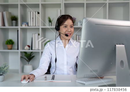 Customer Service Representative Assisting Clients via Computer. Call Center Efficiency Customer Service Representative Assisting Clients via Computer. Call Center Efficiency 117838456