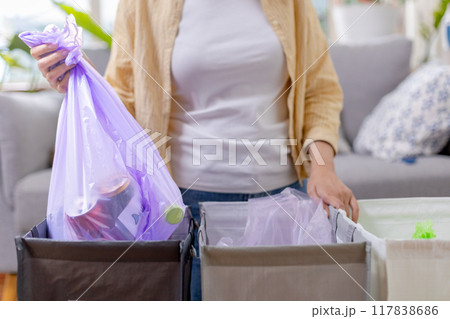 woman is holding bag for sorting garbage. Trash can for Waste sorting in home. 117838686