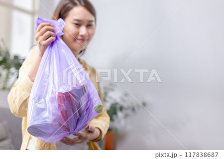 woman is holding bag for sorting garbage. Trash can for Waste sorting in home. 117838687