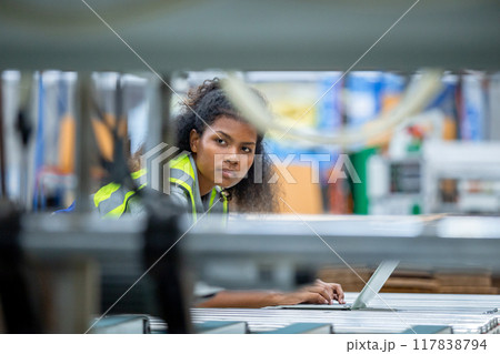 Supervisor worker woman american african using laptop check quality and quantity stock paper product Supervisor worker woman american african using laptop check quality and quantity stock paper product 117838794