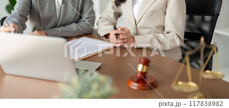 Legal Professionals Reviewing Contract Details on Laptop. Law Firm Strategy Legal Professionals Reviewing Contract Details on Laptop. Law Firm Strategy 117838982