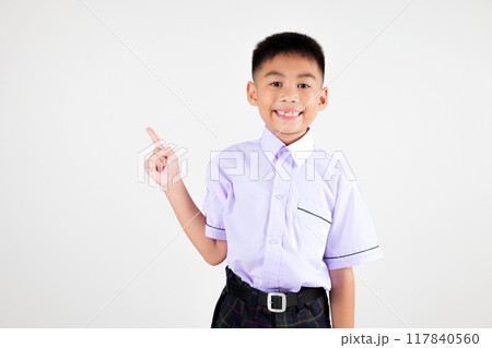 Portrait smile Asian little boy primary posing point finger to side away studio isolated white background, happy cute man kid wear school uniform plaid innocence and curiosity, back to school concept Portrait smile Asian little boy primary posing point finger to side away studio isolated white background, happy cute man kid wear school uniform plaid innocence and curiosity, back to school concept 117840560
