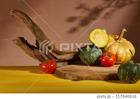 Some fresh vegetables consist of pumpkin and tomato decorated around a blank wooden tray for product presentation. Photo of front view for healthy food advertising Some fresh vegetables consist of pumpkin and tomato decorated around a blank wooden tray for product presentation. Photo of front view for healthy food advertising 117840816