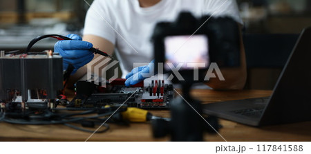 A man makes a vlog on repairing a pc A man makes a vlog on repairing a pc 117841588