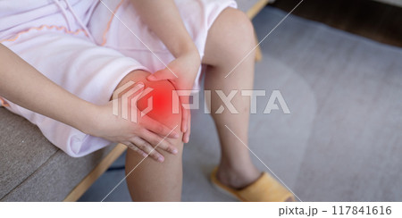 Woman Experiencing Knee Pain at Home. Understanding Joint Discomfort Woman Experiencing Knee Pain at Home. Understanding Joint Discomfort 117841616