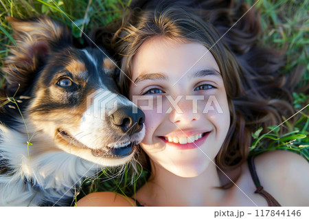 A happy dog and its owner enjoying life with smiles lying on fresh green grass in nature take a selfie photo. Generative AI 117844146