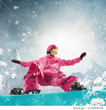 Snowboarder dressed in vibrant pink gear riding down the slope with precision, showing skills and adrenaline of snowboarding experience. 117844236
