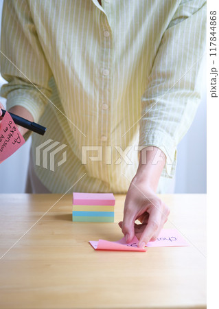 オフィスで課題を見える化する若い女性 117844868