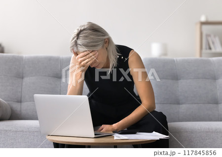 Mature woman depressed about financial concerns and debts 117845856