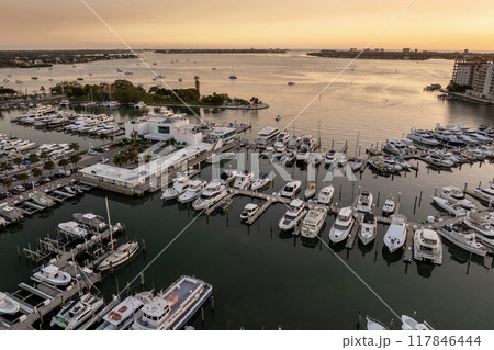 Sarasota, Florida at sunset. Luxury yachts docked in Sarasota Bay marina. American city downtown architecture with high-rise office buildings. USA travel destination Sarasota, Florida at sunset. Luxury yachts docked in Sarasota Bay marina. American city downtown architecture with high-rise office buildings. USA travel destination 117846444