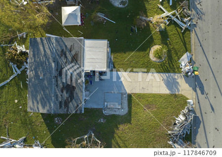 Piles of rubbish on street side from severely damaged houses after hurricane Ian in Florida mobile home residential area. Consequences of natural disaster 117846709
