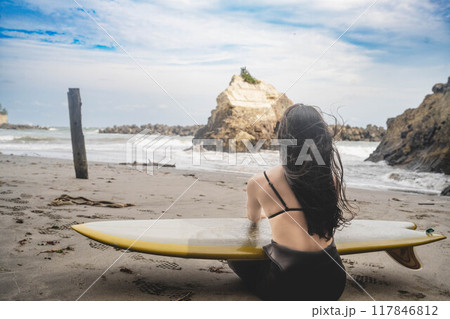 海でサーフィンをする女性の後ろ姿 117846812